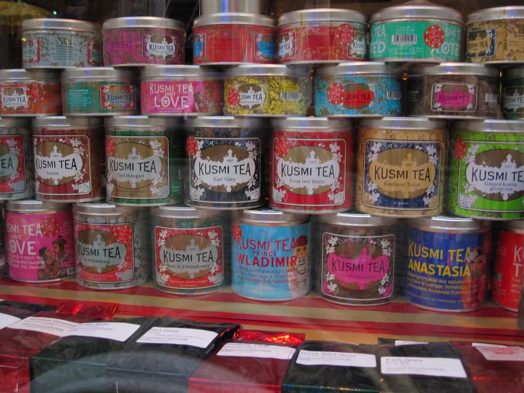 Rows of Kusmi Tea tins on a shop shelf, Anastasia and Prince Vladimir among them.