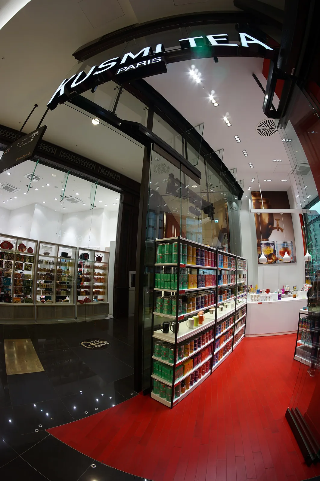 The Kusmi Tea boutique in the Mall of Berlin, Germany: a red floor and walls of coloured tins.