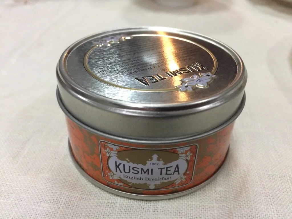 A small Kusmi Tea tin with its red label.