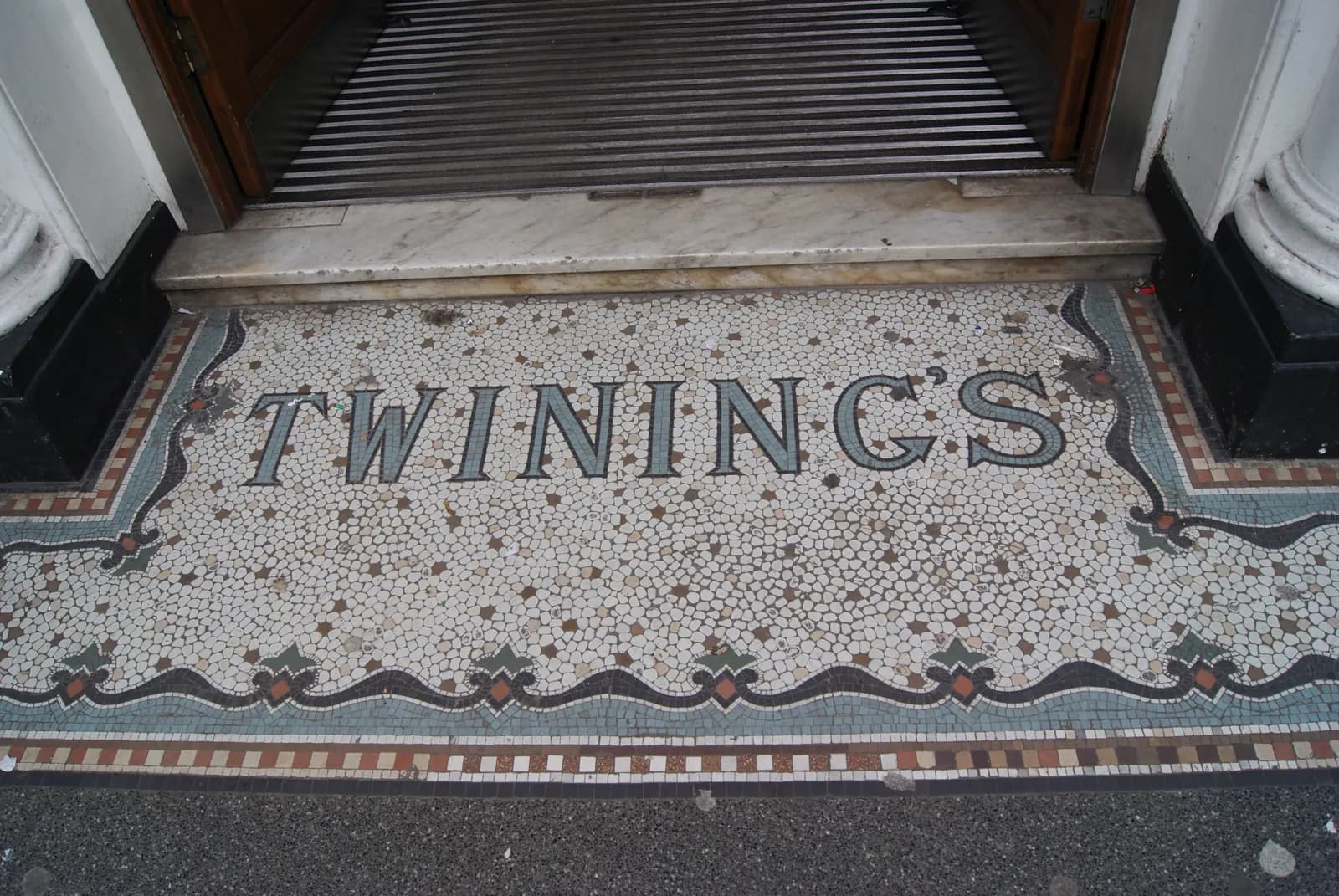 The TWININGS name in a black-and-white mosaic on the doorstep of the shop at 216 Strand.