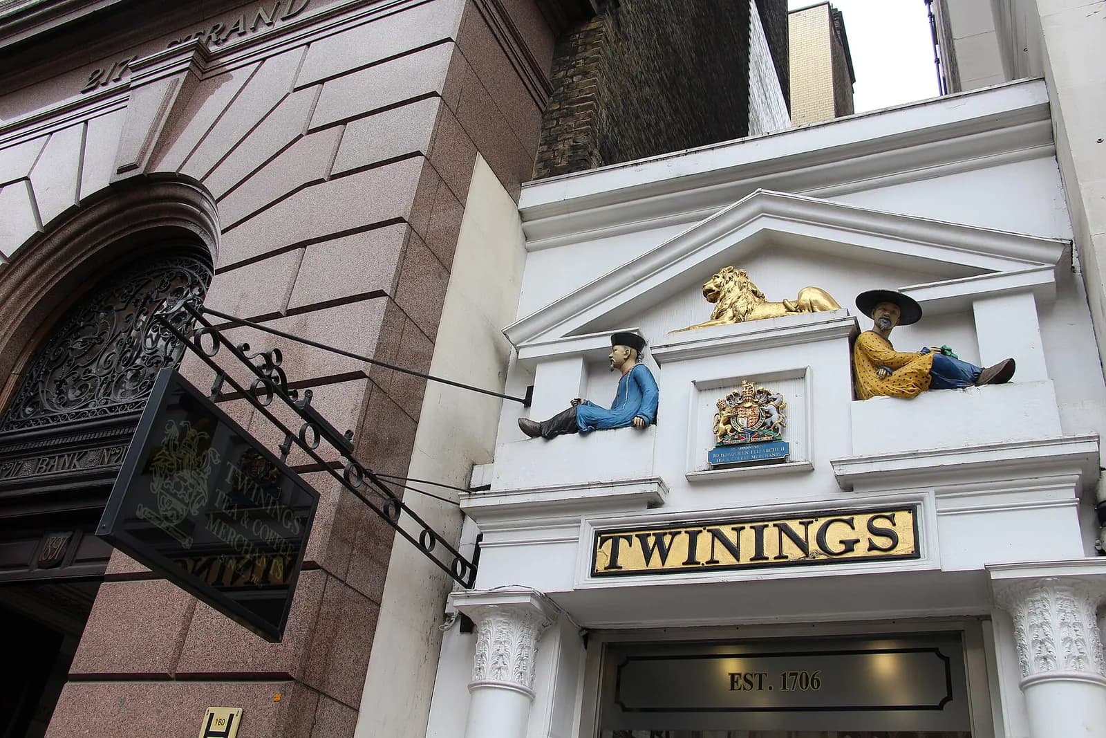 Side view of the Twinings doorway on the Strand, with the lion, the two Chinese figures and 'Est. 1706' over the door.