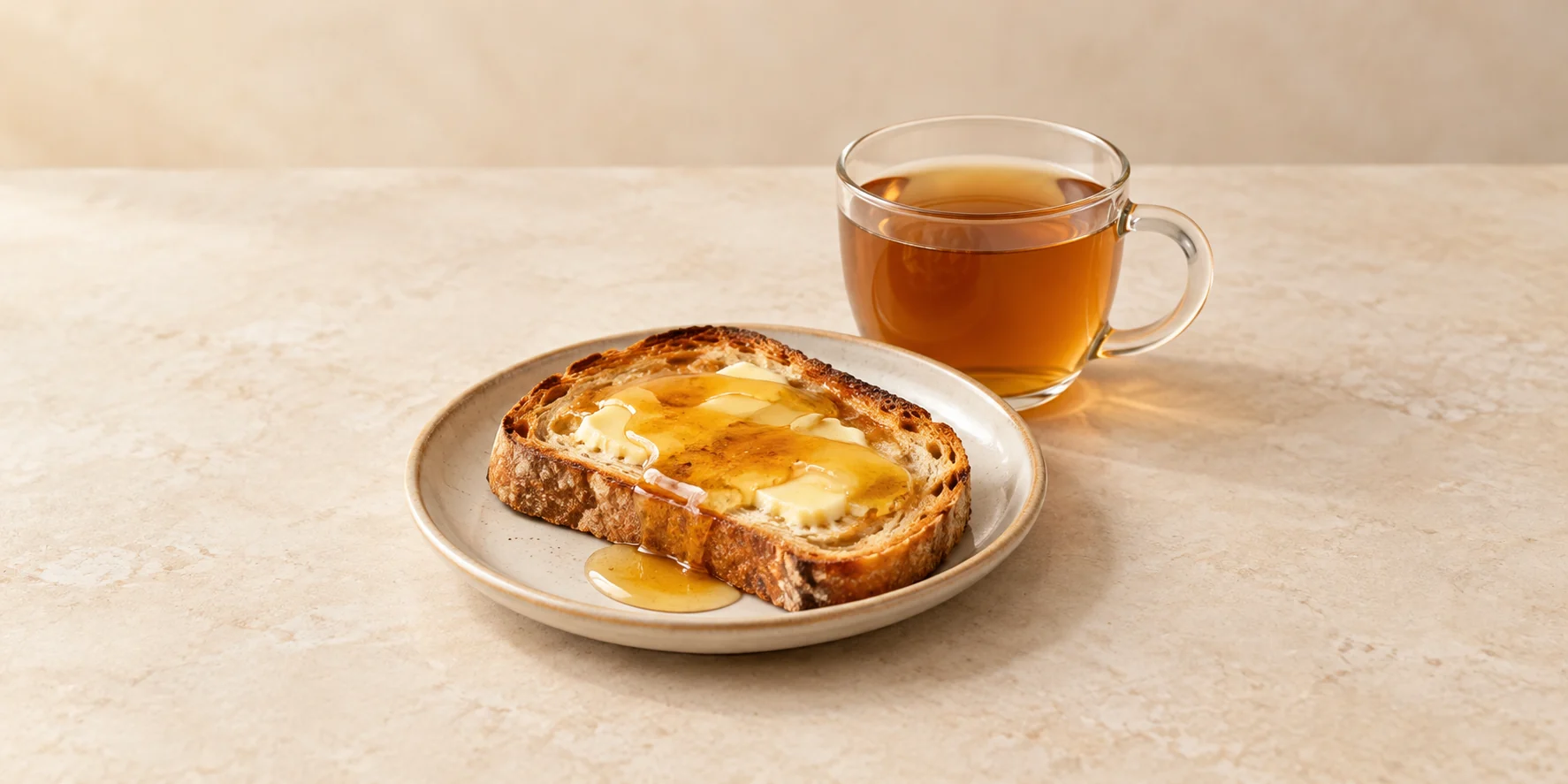 Butter and honey toast beside a cup of valerian tea.