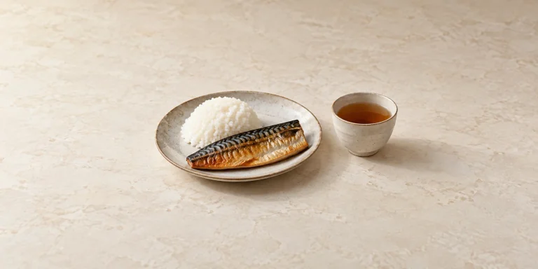 Grilled mackerel and steamed rice beside roasted barley tea.